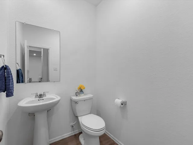 a bathroom with a sink toilet and a mirror
