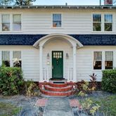 a front view of a house with outdoor seating and plants