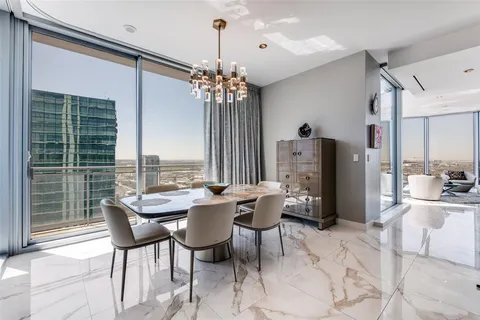 a dining room with furniture a chandelier and window