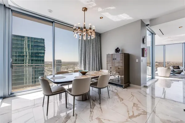 a dining room with furniture a chandelier and window