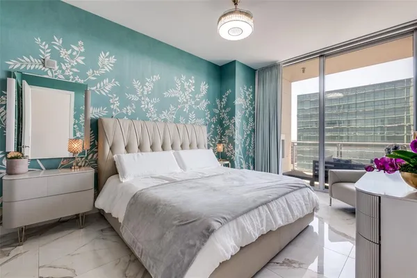 a bedroom with a bed and a chandelier