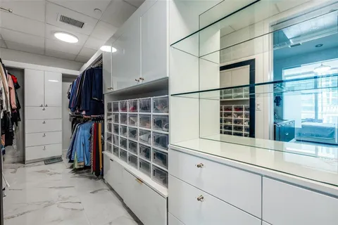 a view of walk in closet and window