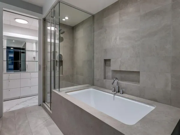 a bathroom with a tub sink and shower