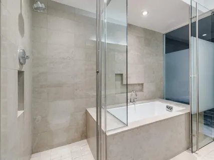 a bathroom with a bathtub and shower