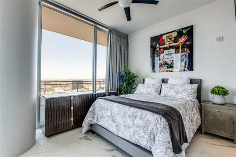 a bedroom with a bed and a large window