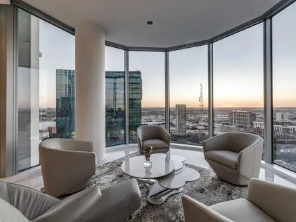 a living room with furniture and a floor to ceiling window