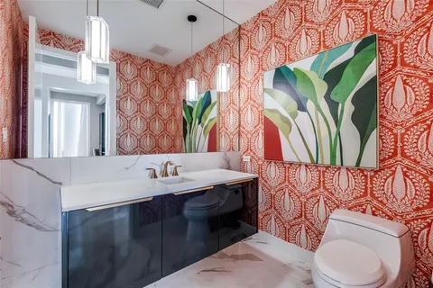 a bathroom with a sink a toilet and a mirror