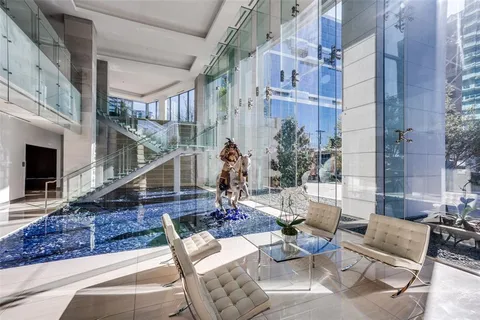 a living room with furniture and large windows