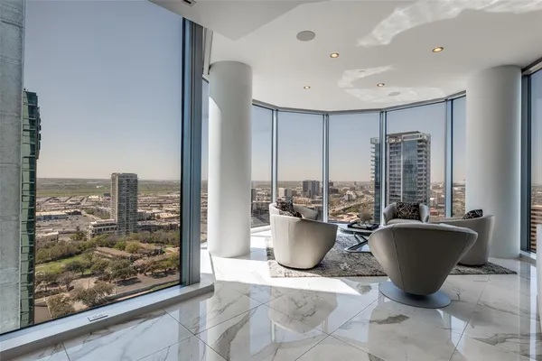 a living room with furniture a window and a potted plant