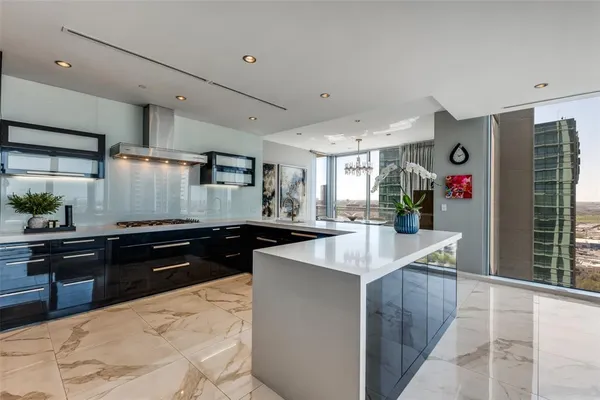 a kitchen with stainless steel appliances kitchen island granite countertop a sink and cabinets