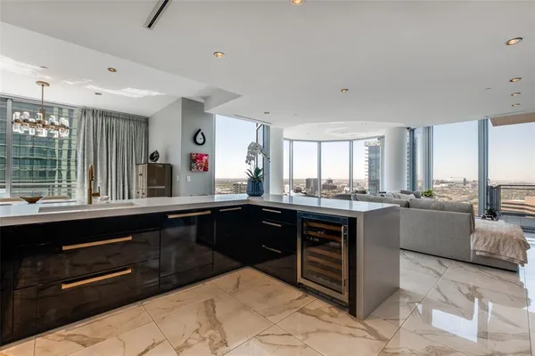a kitchen with granite countertop a sink cabinets and wooden floor