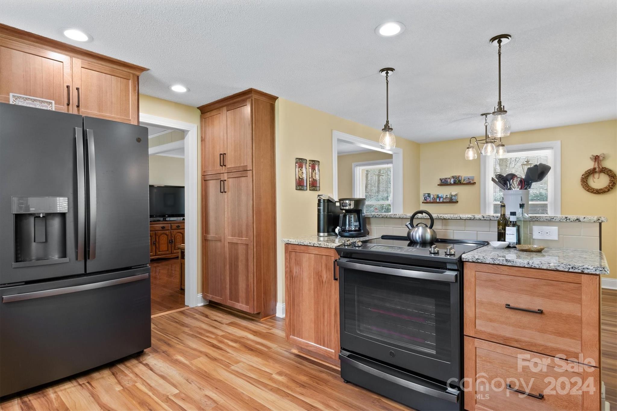 215 6th Street Northeast Conover, NC 28613 - Photo 12 of 47 a kitchen with stainless steel appliances granite countertop a refrigerator a sink dishwasher a stove and a wooden floor