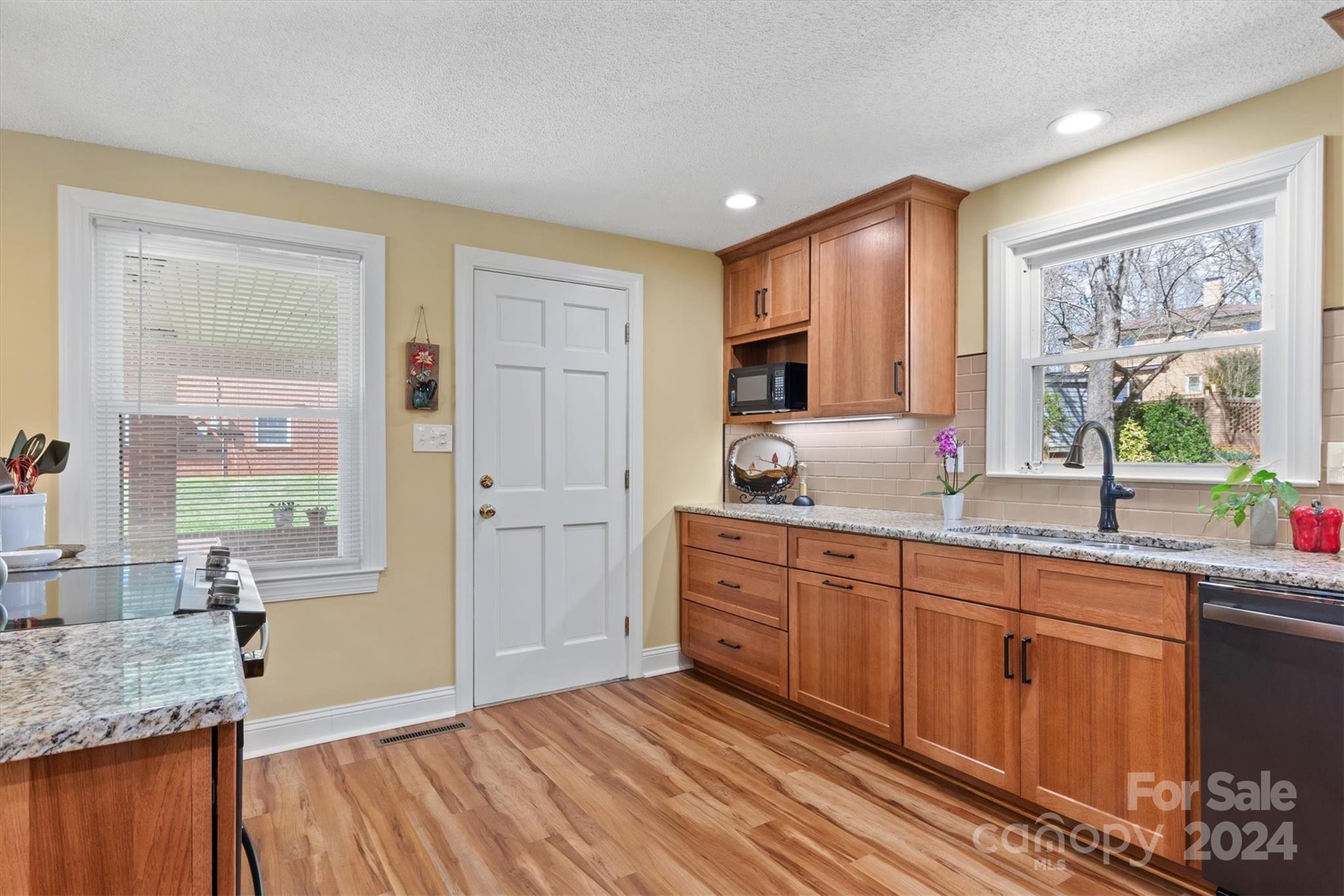 215 6th Street Northeast Conover, NC 28613 - Photo 14 of 47 a spacious bathroom with a granite countertop sink mirror and a large window