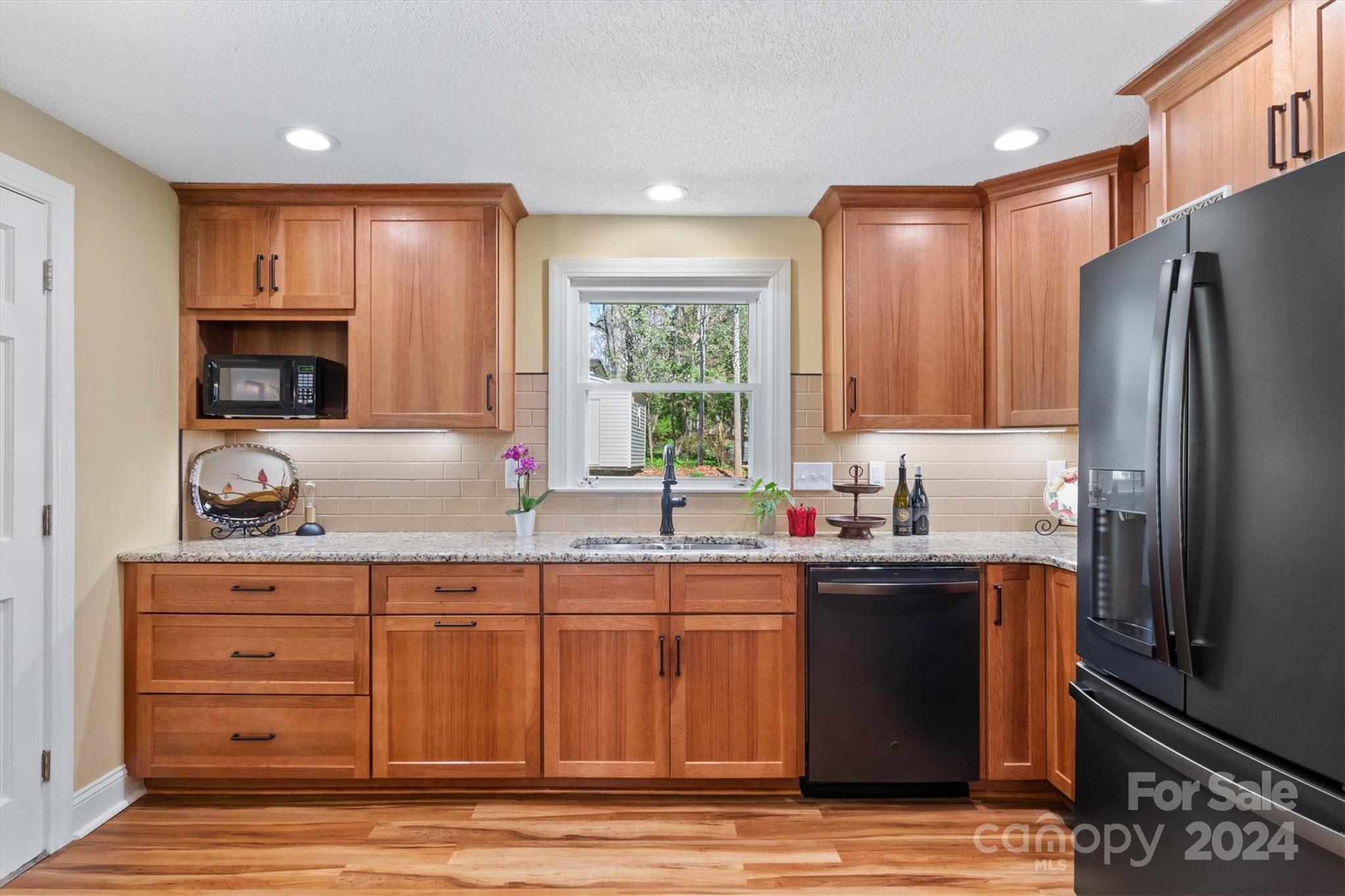 215 6th Street Northeast Conover, NC 28613 - Photo 15 of 47 a kitchen with kitchen island granite countertop a sink stove and refrigerator