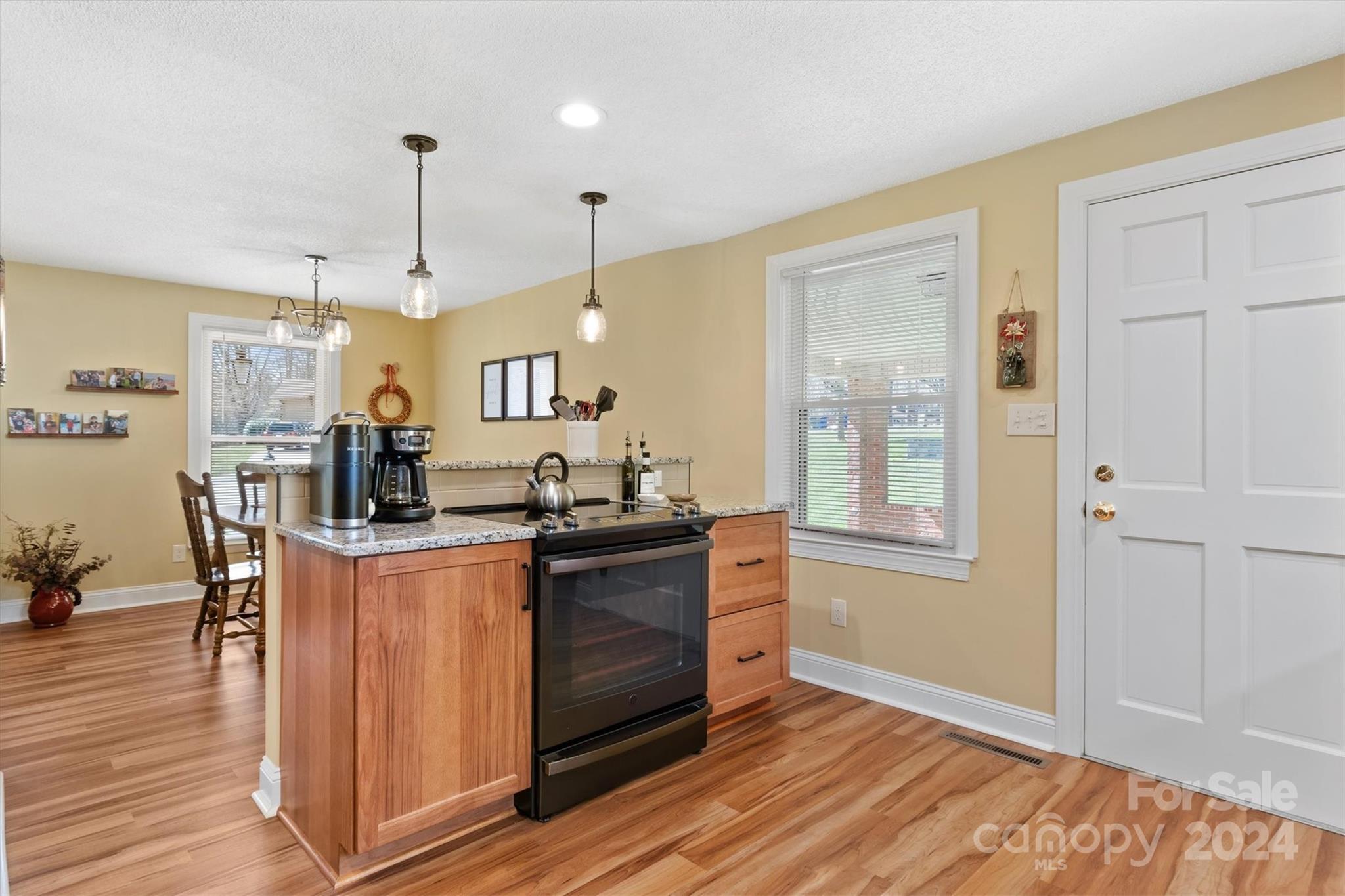 215 6th Street Northeast Conover, NC 28613 - Photo 21 of 47 a kitchen with stainless steel appliances kitchen island granite countertop a stove and a refrigerator