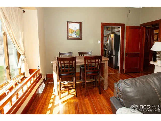 a dining room with furniture and wooden floor