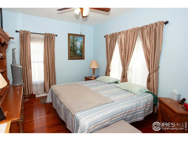 a bedroom with a bed and a large mirror