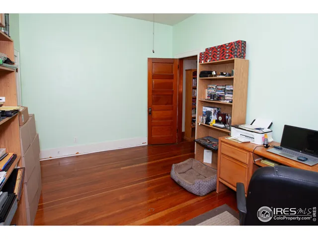 a room with a table and a book shelf