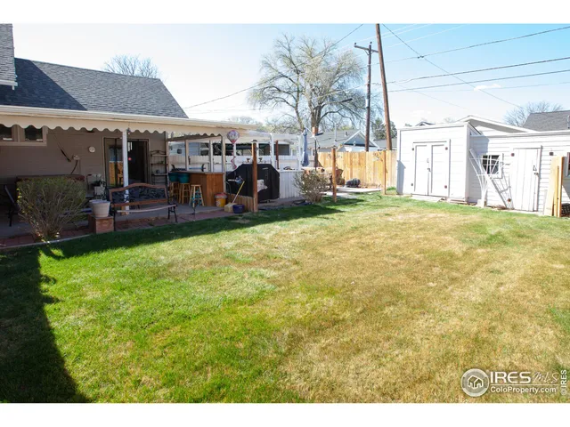 a view of an house with backyard and patio