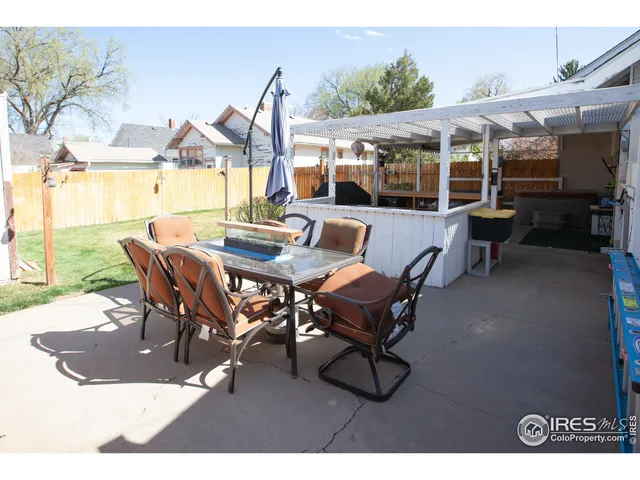 a view of a patio with table and chairs