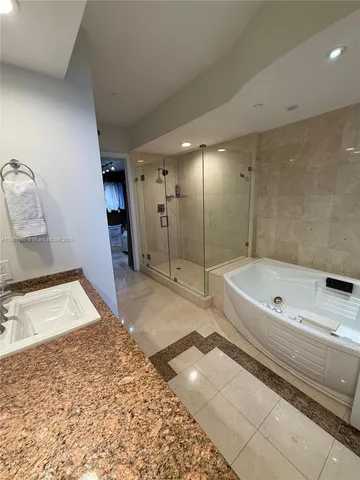 a bathroom with a tub a toilet and a shower