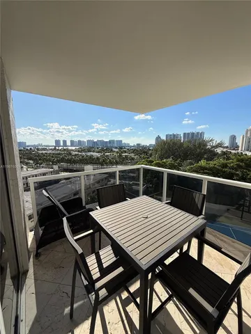 a view of a roof deck with dining table and chairs