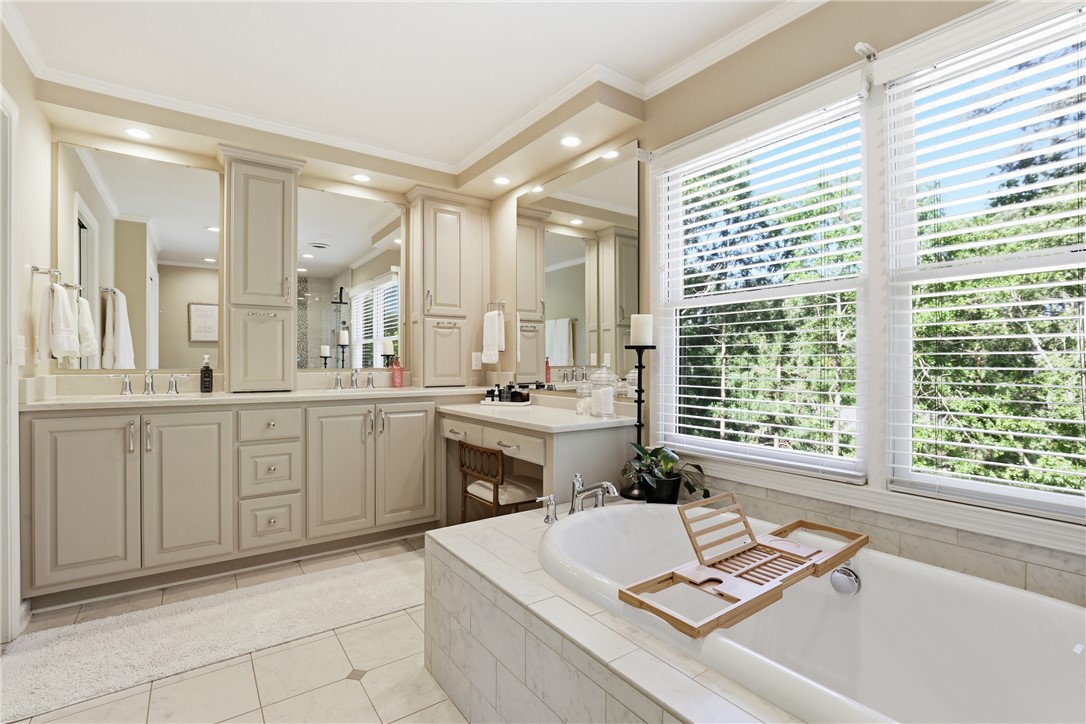 103 5 Knoll Court Anderson, SC 29621 - Photo 16 of 33 Indulge in a primary bathroom oasis, featuring a deep soaking tub and dual vanities.