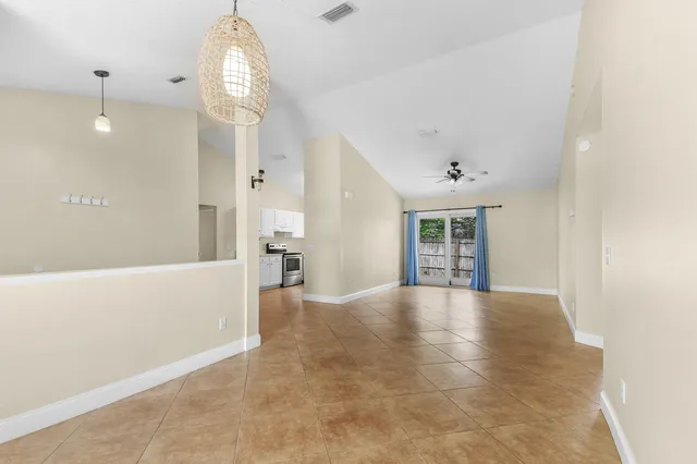 a view of an empty room with window and cabinet
