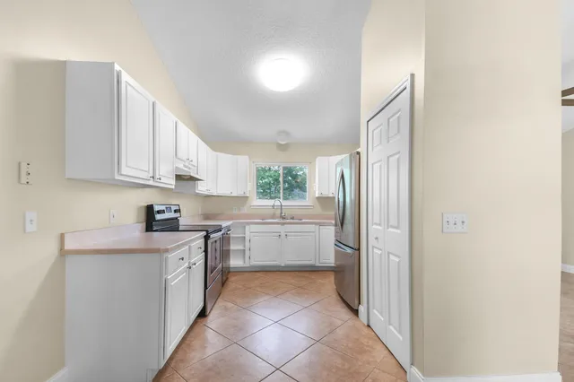 a kitchen with a cabinets and window