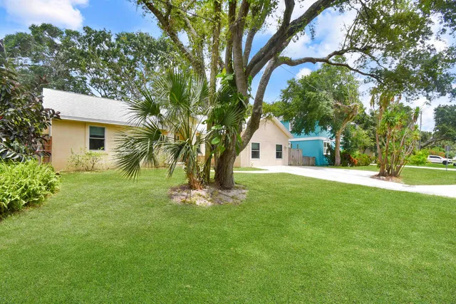 a front view of house with a garden