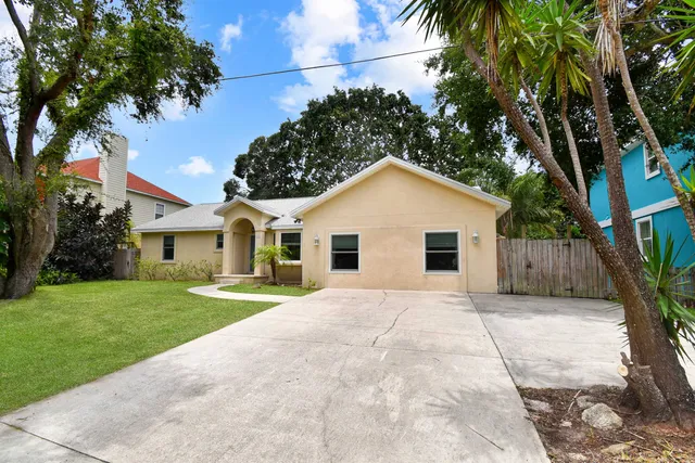 a view of a yard in front view of a house