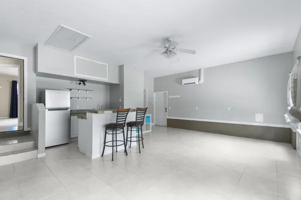 a view of kitchen with furniture and white appliances