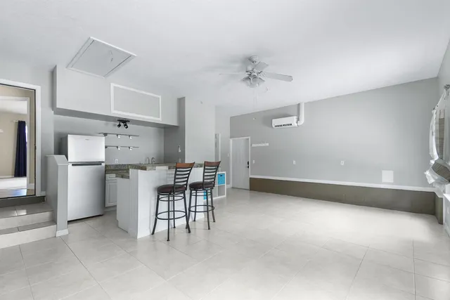 a view of kitchen with furniture and white appliances