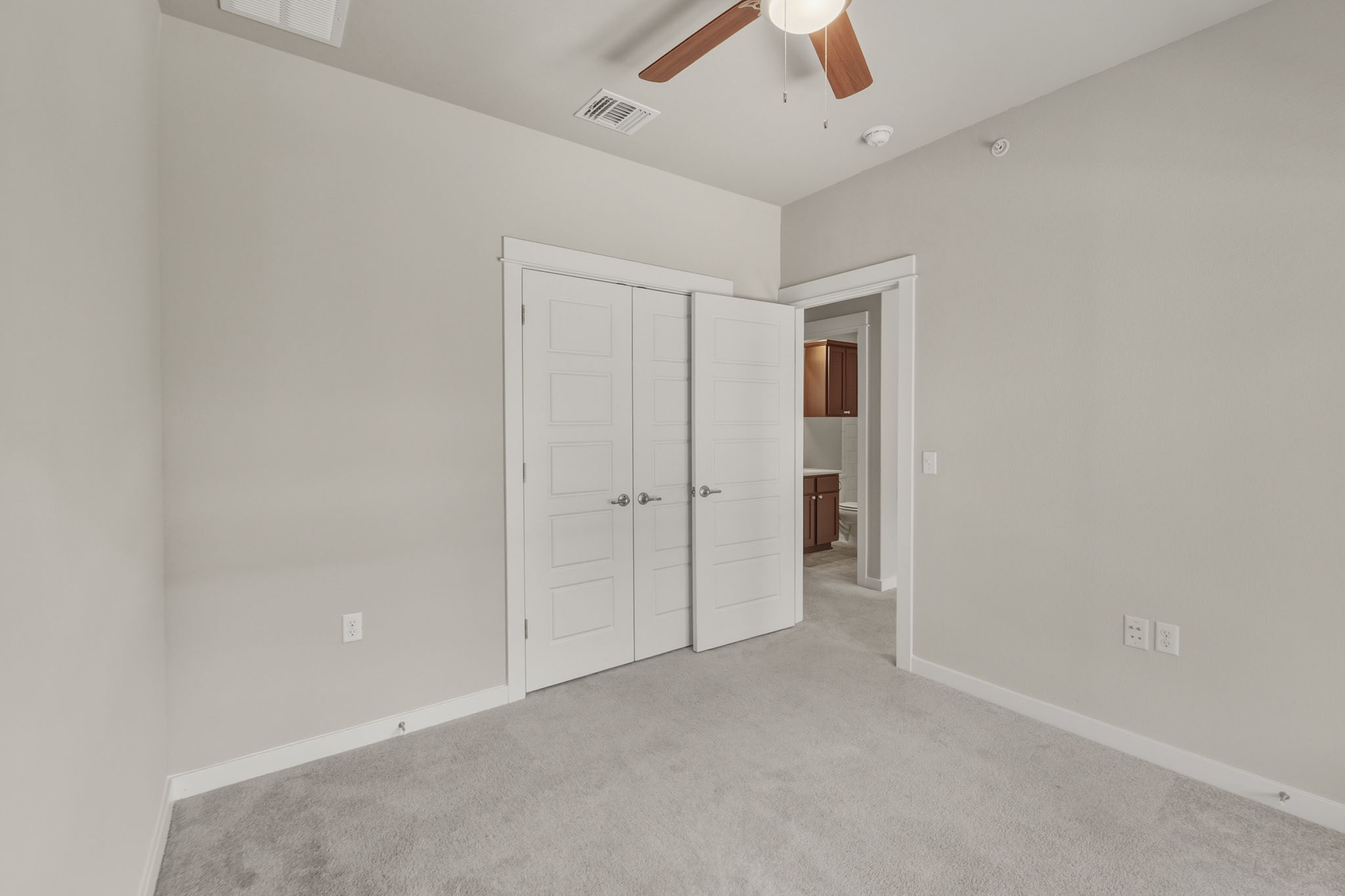 3919 Vaughan Street Austin, TX 78723 - Photo 36 of 40 A comfortable bedroom with a ceiling fan and a soft carpeted floor.