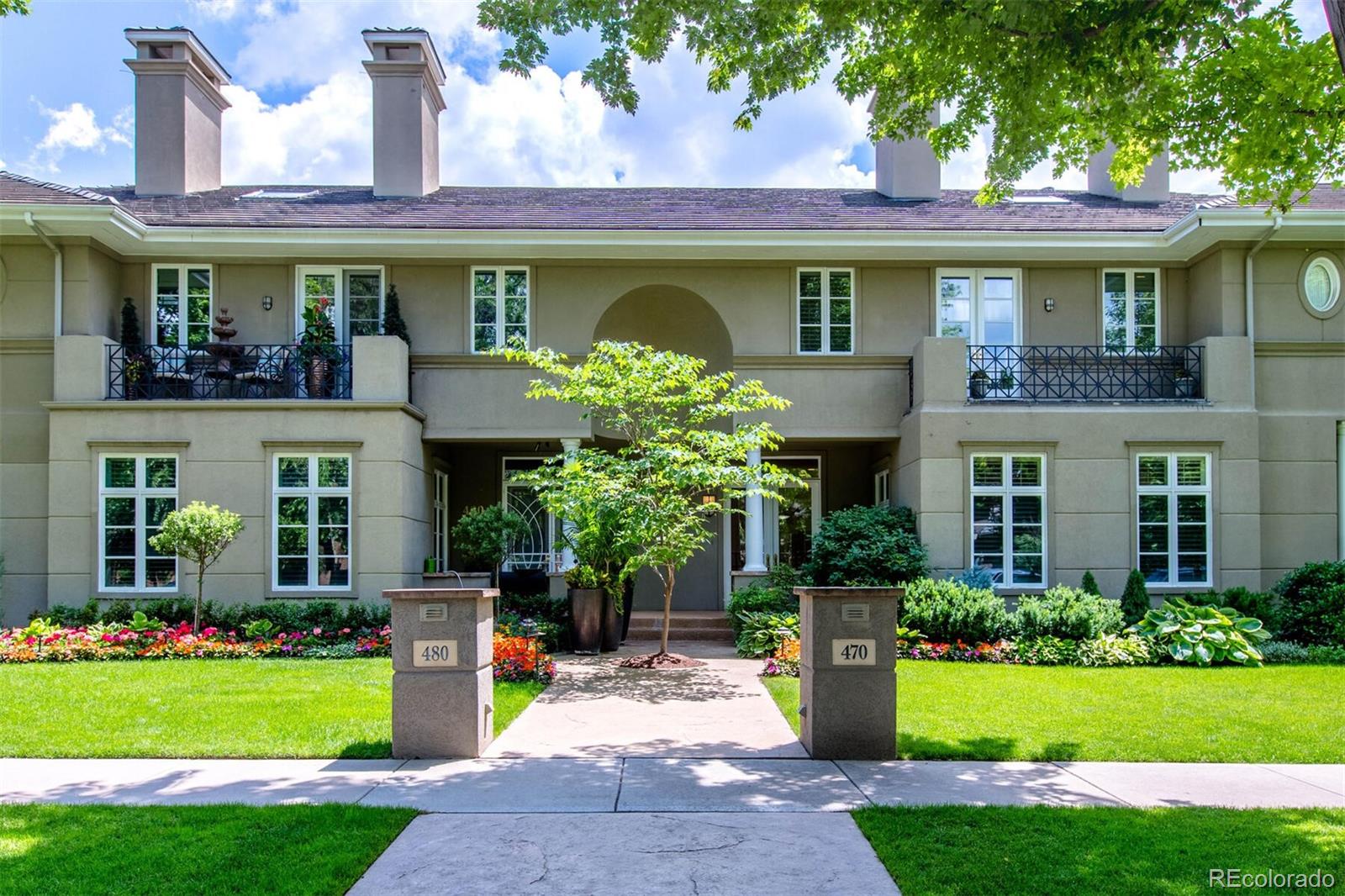 470 Monroe Street Denver, CO 80206 - Photo 1 of 40 a front view of a house with a yard and potted plants