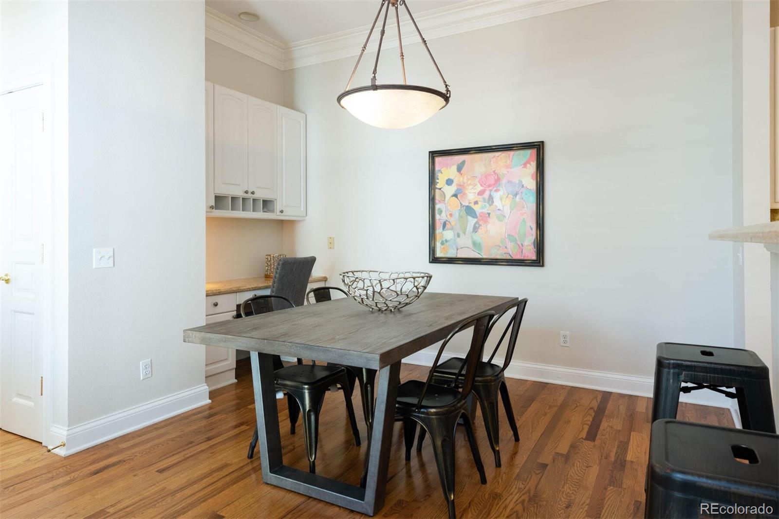 470 Monroe Street Denver, CO 80206 - Photo 12 of 40 a view of a dining room with furniture and wooden floor