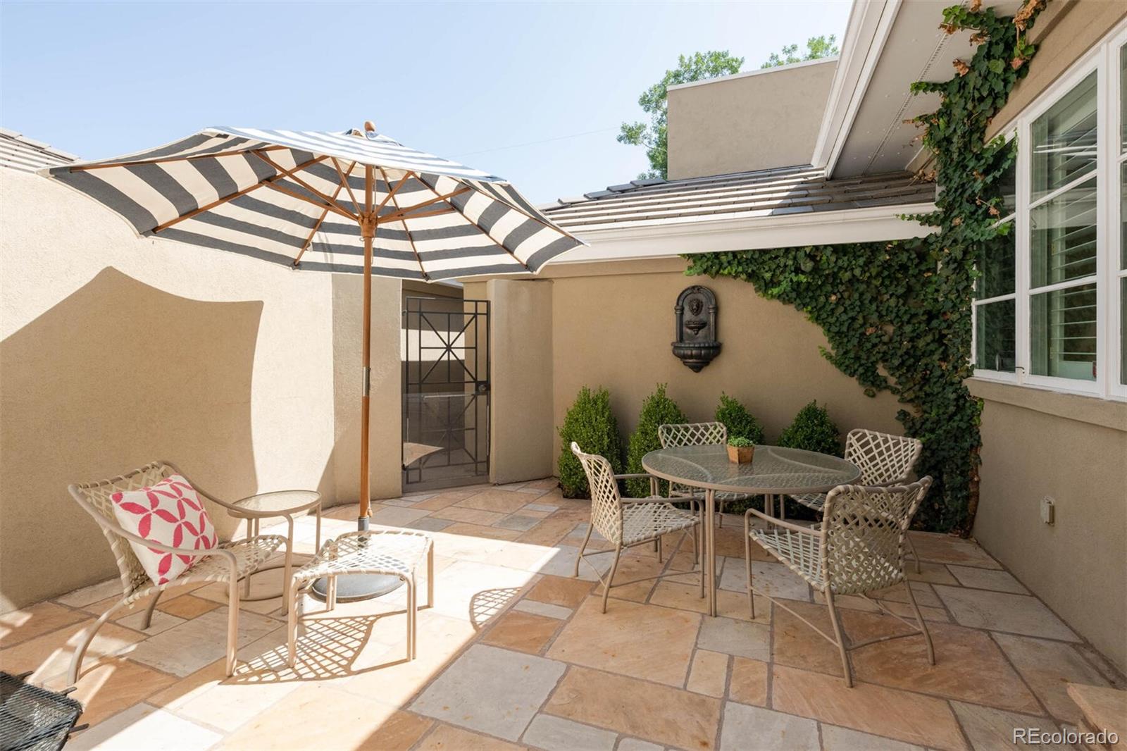470 Monroe Street Denver, CO 80206 - Photo 19 of 40 a view of a patio with table and chairs potted plants