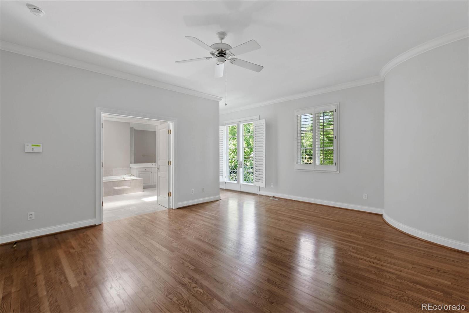 470 Monroe Street Denver, CO 80206 - Photo 25 of 40 a view of an empty room with a window and wooden floor