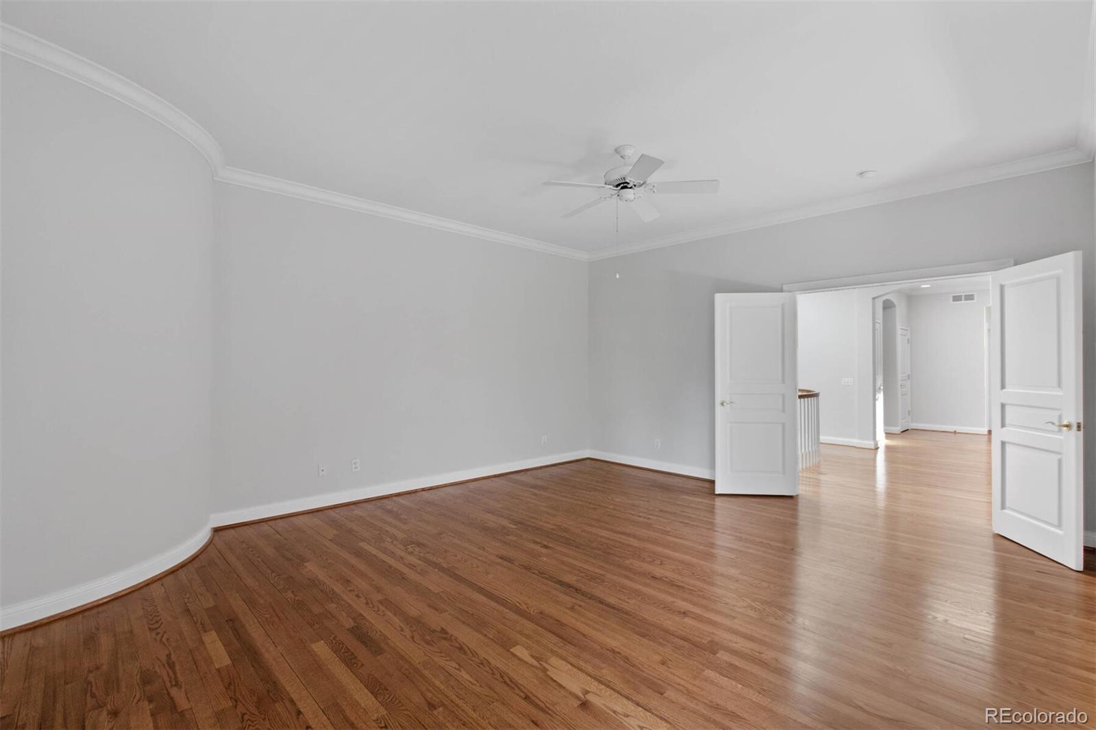 470 Monroe Street Denver, CO 80206 - Photo 26 of 40 a view of an empty room with wooden floor
