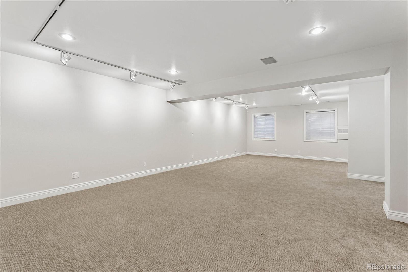 470 Monroe Street Denver, CO 80206 - Photo 34 of 40 an empty room with windows and ceiling fan