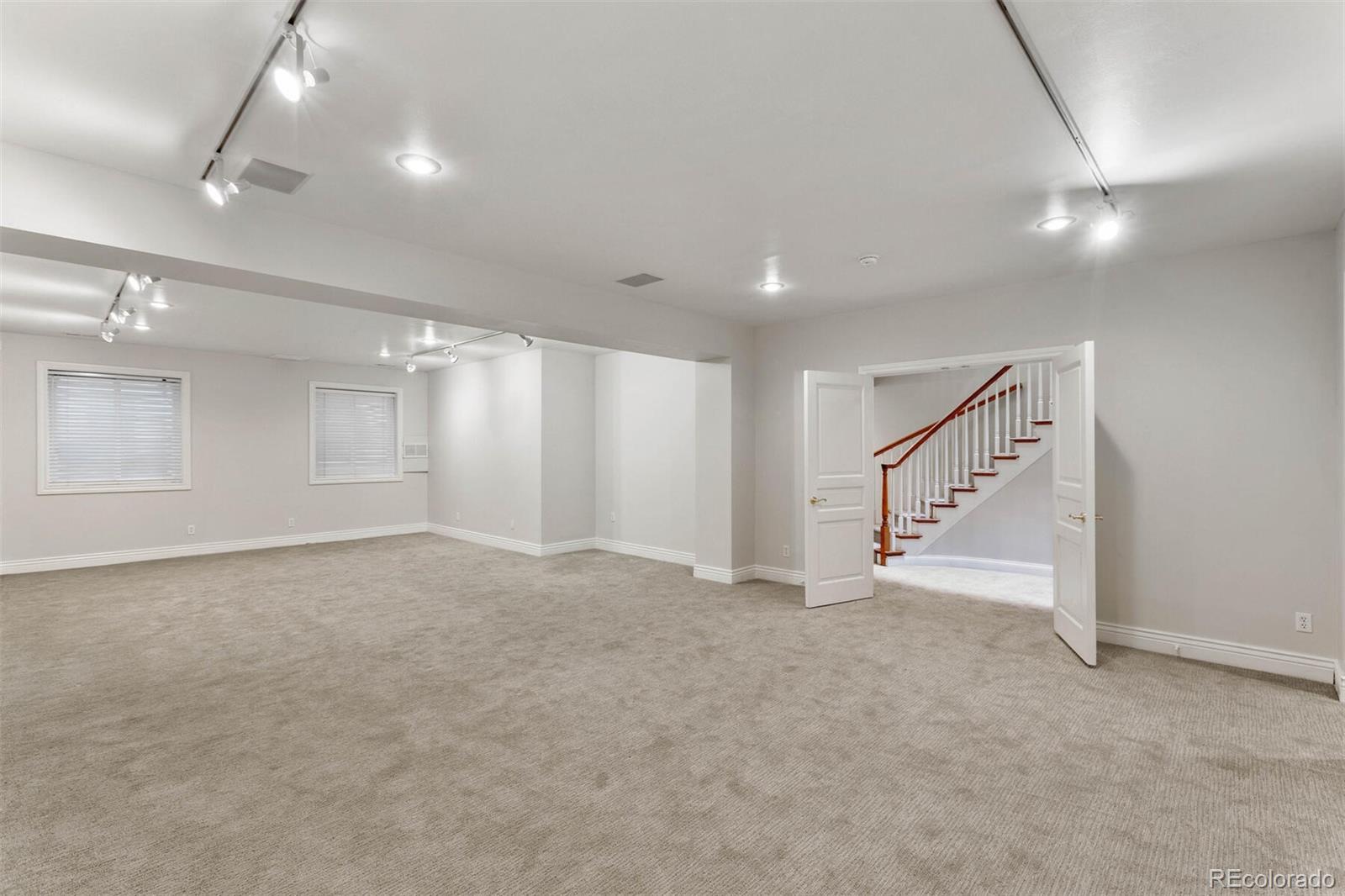 470 Monroe Street Denver, CO 80206 - Photo 35 of 40 an empty room with staircase and white walls