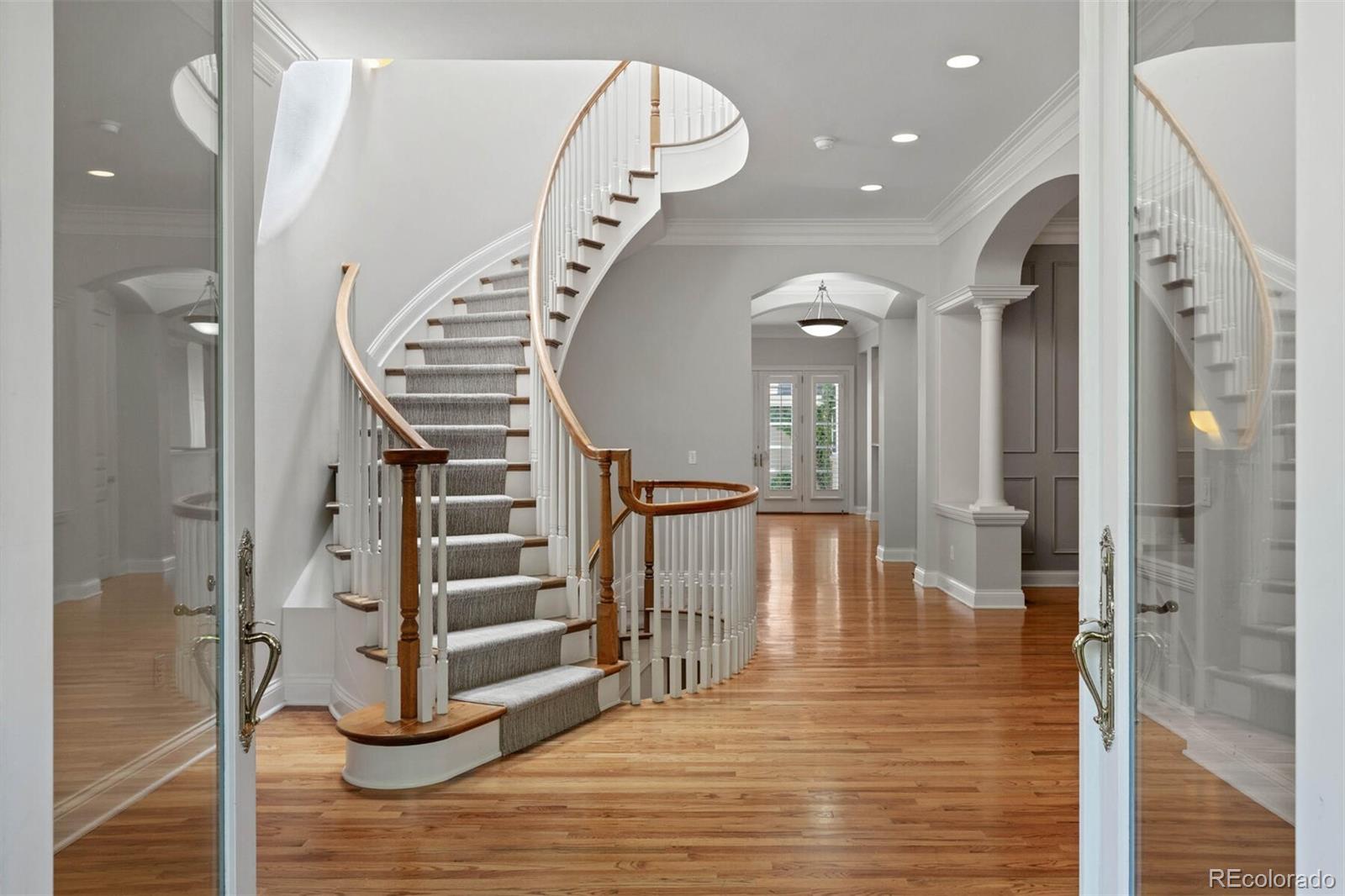 470 Monroe Street Denver, CO 80206 - Photo 37 of 40 a view of a hallway with wooden floor and staircase
