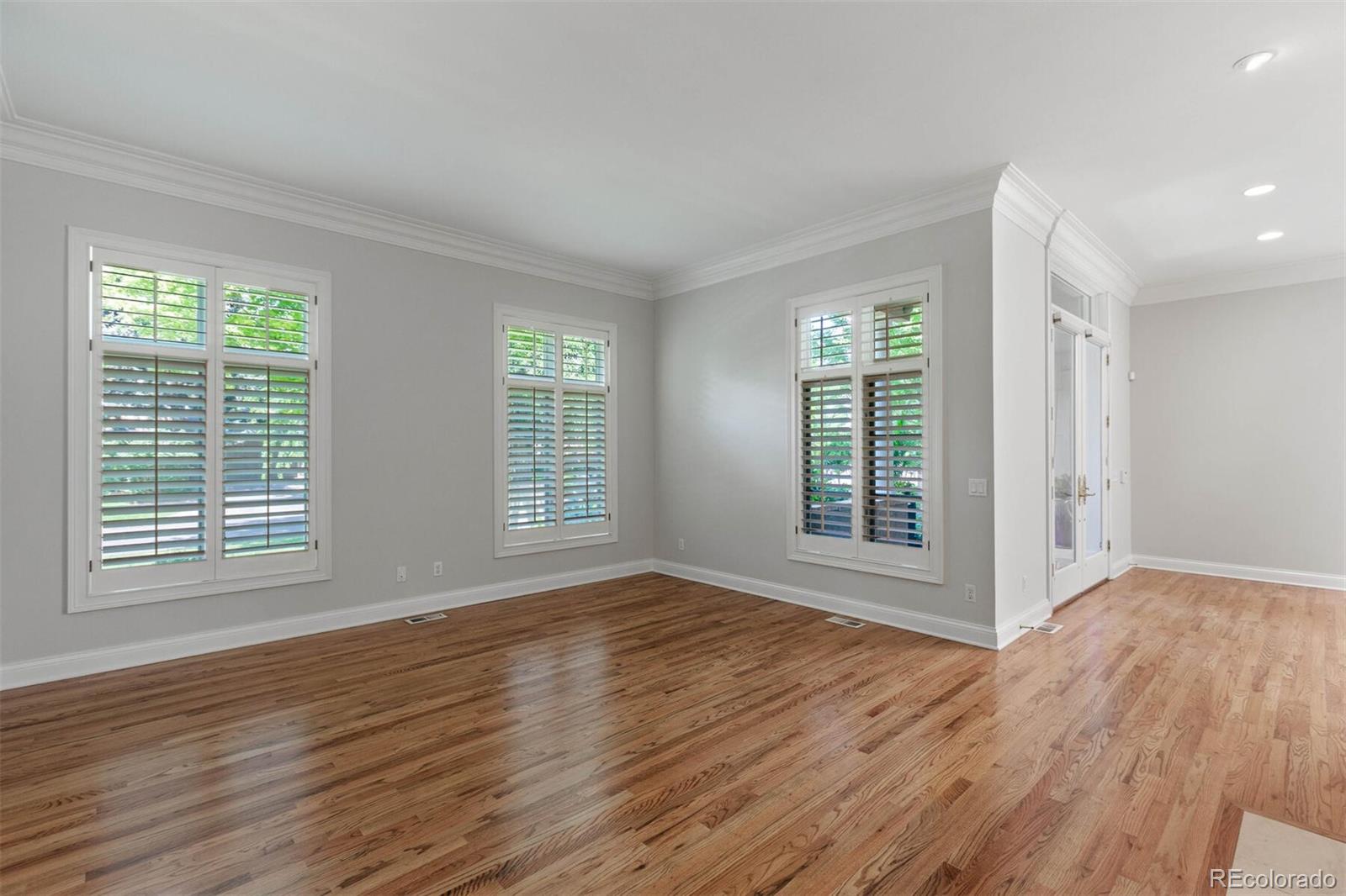 470 Monroe Street Denver, CO 80206 - Photo 40 of 40 a view of an empty room with wooden floor and a window