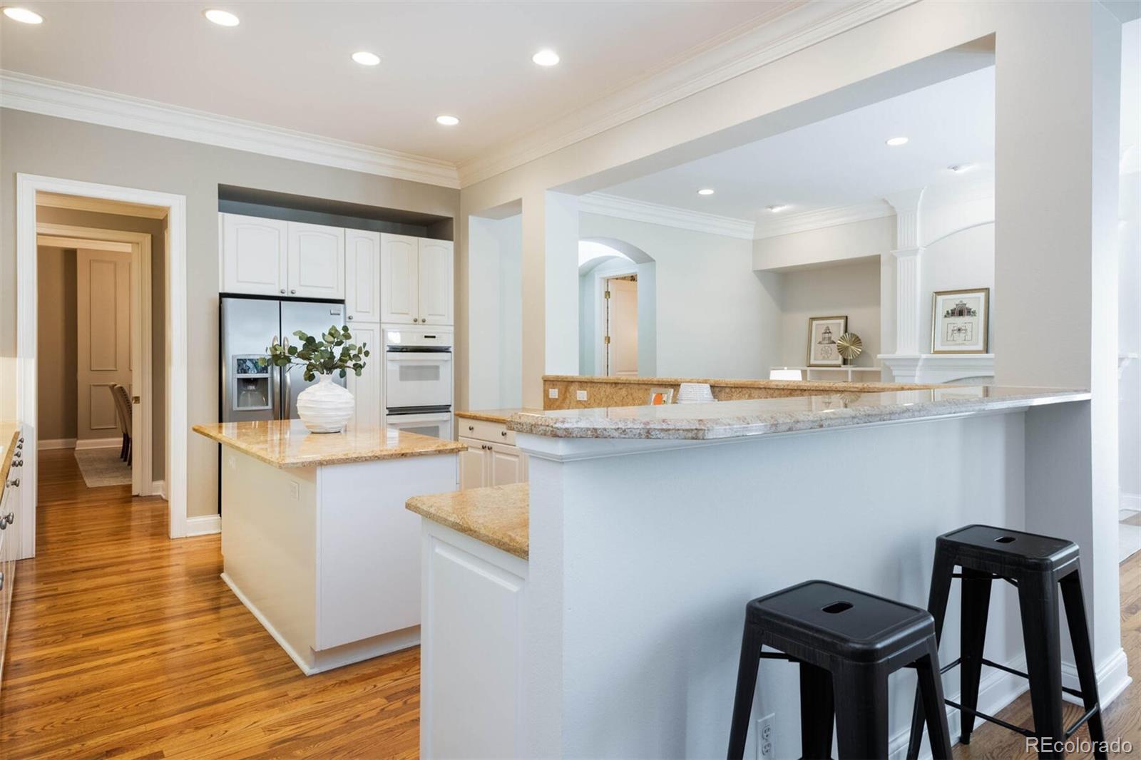470 Monroe Street Denver, CO 80206 - Photo 9 of 40 a kitchen with granite countertop white cabinets and stainless steel appliances