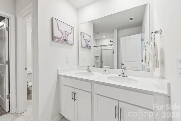 a bathroom that has a glass shower door