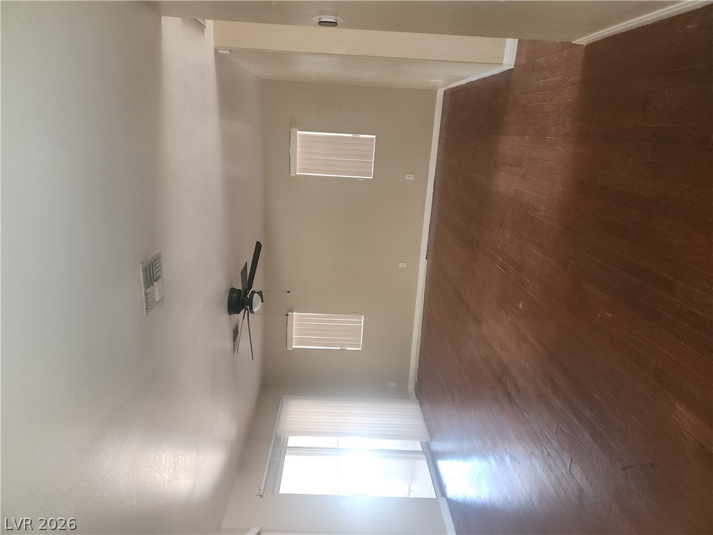 564 Ridgeway Road Henderson, NV 89015 - Photo 9 of 22 Sun-filled spaces boast rich wood flooring and practical window blinds, ready for your personalized touch.