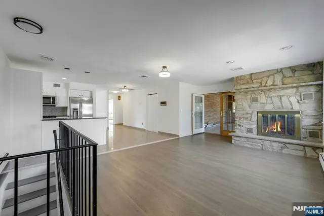 a view of a room with kitchen and fireplace