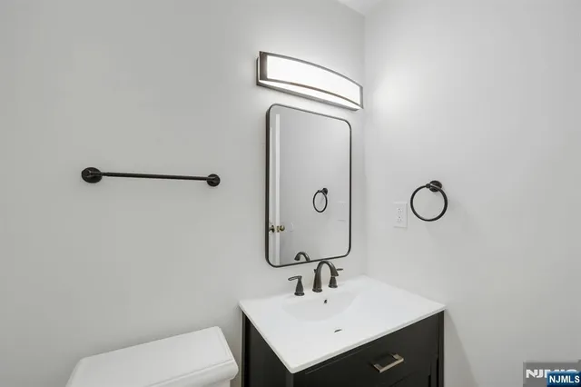a bathroom with a sink toilet and vanity