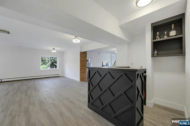 a view of a utility room with wooden floor and windows