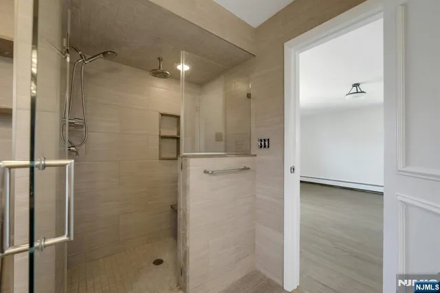 a bathroom with a shower and a glass door